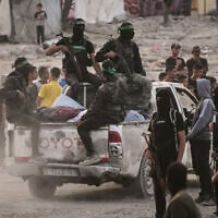 Hamas operatives search for the bodies of Israeli hostages in the Shejaiya neighborhood of Gaza City, November 5, 2025. (AP Photo/Jehad Alshrafi)