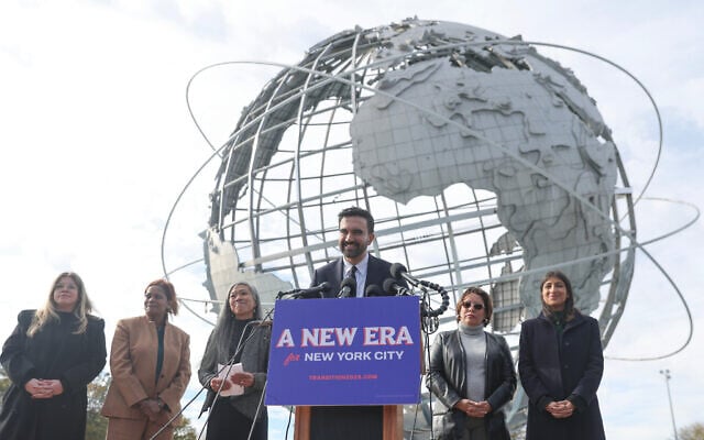 New York City Mayor-elect Zohran Mamdani, center, speaks in front of the Unisphere alongside his transition team, in Queens, New York City, November 5, 2025. (AP Photo/Heather Khalifa)