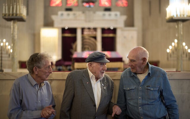 Holocaust survivors Walter Bingham, 101, center, George Shefi, 94, right, and Paul Alexander, 87, talk as they pose for a photo after an interview at Jerusalem Great Synagogue in Jerusalem, Nov. 5, 2025, ahead the 87th anniversary of Kristallnacht (AP Photo/Leo Correa)