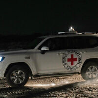 A Red Cross convoy carrying the body of a deceased hostage handed over by Hamas makes its way toward the border crossing with Israel, to be transferred to Israeli authorities, in Deir al-Balah, central Gaza Strip, Friday, Nov. 7, 2025. (AP Photo/Abdel Kareem Hana)
