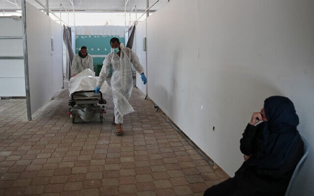 Bodies of unidentified Palestinians returned from Israel as part of the ceasefire deal are brought to Nasser Hospital in Khan Younis, Gaza Strip, November 8, 2025. (AP Photo/Abdel Kareem Hana)