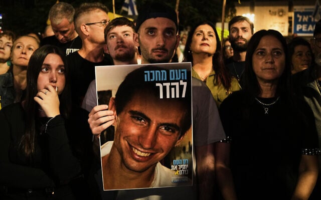Freed Israeli hostage Matan Angrest holds a photo of Hadar Goldin during a rally calling for the return of the deceased hostages who are held by Hamas in the Gaza Strip, in Tel Aviv, Israel, Saturday, Nov. 8, 2025. (AP/Mahmoud Illean)
