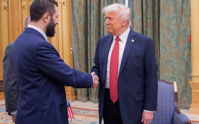 In this photo released by the Saudi Royal Palace, US President Donald Trump, right, shakes hands with Syria's President Ahmad al-Sharaa in Riyadh, Saudi Arabia, May 14, 2025. (Bandar Aljaloud/Saudi Royal Palace via AP, File)