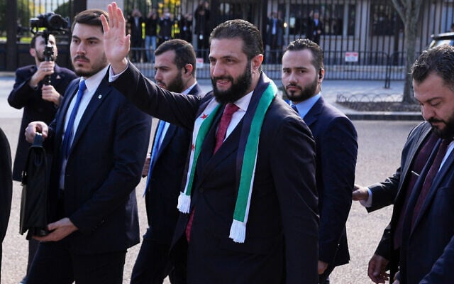 Syria's President Ahmed al-Sharaa waves as he greets supporters outside of the White House, November 10, 2025, in Washington, following a meeting with US President Donald Trump. (AP Photo/Jacquelyn Martin)