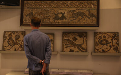 A visitor looks at ancient mosaics on display at the National Museum of Syria in Damascus, May 23, 2025. (AP/Ghaith Alsayed)