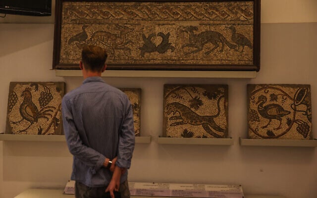 A visitor looks at ancient mosaics on display at the National Museum of Syria in Damascus, May 23, 2025. (AP/Ghaith Alsayed)