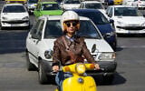 Merat Behnam drives her motorbike in downtown Tehran, Iran, November 1, 2025. (AP Photo/Vahid Salemi)