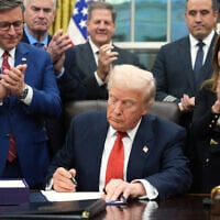 US President Donald Trump signs the funding bill to reopen the government, in the Oval Office of the White House in Washington, November 12, 2025. (Jacquelyn Martin/AP)