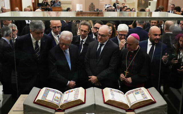 From right, Monsignor Rino Fisichella, Rome's Mayor Roberto Gualtieri and Italian government undersecretary Alfredo Mantovano look at the 15th century Borso D'Este Bible, after its unveiling at the Italian Senate as part of the Vatican's Holy Year celebrations in Rome, Nov. 13, 2025. (AP Photo/Alessandra Tarantino) From right, Monsignor Rino Fisichella, Rome's Mayor Roberto Gualtieri and Italian government undersecretary Alfredo Mantovano look at the 15th century Borso D'Este Bible, after its unveiling at the Italian Senate as part of the Vatican's Holy Year celebrations in Rome, Nov. 13, 2025. (AP Photo/Alessandra Tarantino)