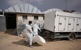 Bodies of unidentified Palestinians returned from Israel as part of the ceasefire deal are carried in Nasser Hospital in Khan Younis, Gaza Strip, Friday, Nov. 14, 2025. (AP Photo/Abdel Kareem Hana)