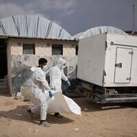 Bodies of unidentified Palestinians returned from Israel as part of the ceasefire deal are carried in Nasser Hospital in Khan Younis, Gaza Strip, Friday, Nov. 14, 2025. (AP Photo/Abdel Kareem Hana)