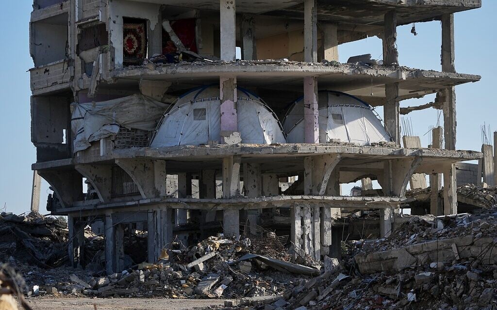 Tents are set up inside a gutted apartment building in Khan Younis, in the southern Gaza Strip, November 15, 2025. (AP Photo/Abdel Kareem Hana)