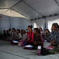 Palestinian students attend class inside a tent set up on the beach in Khan Younis, Gaza Strip, November 12, 2025. (AP Photo/Abdel Kareem Hana)