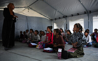 Palestinian students attend class inside a tent set up on the beach in Khan Younis, Gaza Strip, November 12, 2025. (AP Photo/Abdel Kareem Hana) Palestinian students attend class inside a tent set up on the beach in Khan Younis, Gaza Strip, November 12, 2025. (AP Photo/Abdel Kareem Hana)