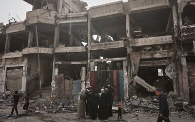 Palestinians inspect the aftermath of an Israeli strike on a building in Gaza City, a day after the strike, on November 20, 2025. (AP Photo/Jehad Alshrafi)