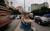 Cars speed past a roadside statue depicting the Virgin Mary holding the body of Jesus, in Beirut, Lebanon, November 13, 2025. (Hassan Ammar/AP)