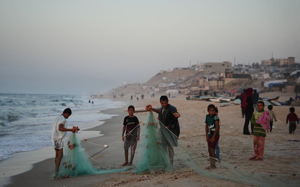 Palestinian fishermen pull in their net from the Mediterranean Sea at the coast of Zawaida, central Gaza Strip, Friday, Nov. 21, 2025. (AP Photo/Abdel Kareem Hana) Palestinian fishermen pull in their net from the Mediterranean Sea at the coast of Zawaida, central Gaza Strip, Friday, Nov. 21, 2025. (AP Photo/Abdel Kareem Hana)