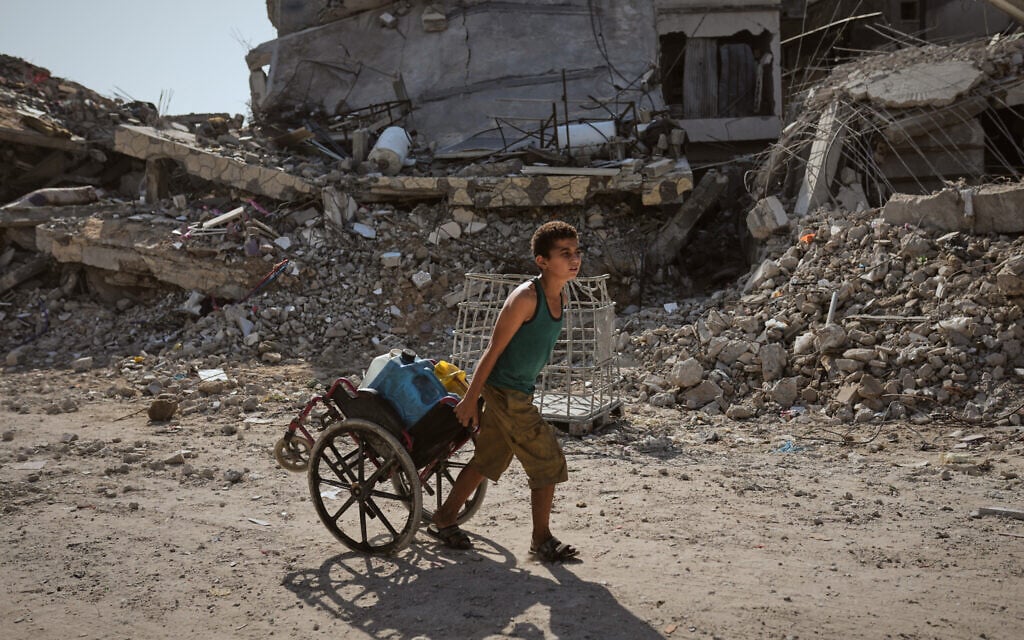 A child pulls a wheelchair loaded with plastic jerrycans of water in Jabalia, Gaza, Friday, Nov. 21, 2025. (AP Photo/Jehad Alshrafi) A child pulls a wheelchair loaded with plastic jerrycans of water in Jabalia, Gaza, Friday, Nov. 21, 2025. (AP Photo/Jehad Alshrafi)