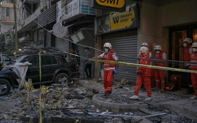 Lebanese Red Cross volunteers work at the site where an apartment building was hit during an Israeli airstrike in the southern suburb of Beirut, on November 23, 2025. (AP Photo/Bilal Hussein)