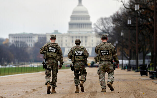 National Guard patrol along the National Mall in front of the Capitol, November 26, 2025, in Washington. (AP Photo/Rahmat Gul)