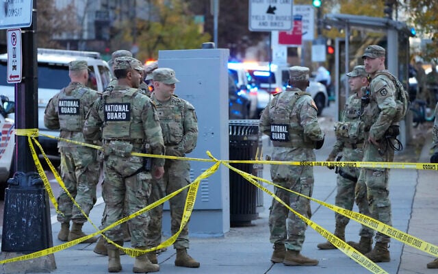 Members of the National Guard gather after reports of two National Guard soldiers were shot near the White House in Washington, November 26, 2025. (Mark Schiefelbein/AP Photo)