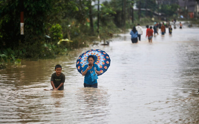 People wade through the water at a flooded street in Medan, North Sumatra, Indonesia, November 27, 2025. (AP Photo/Binsar Bakkara) People wade through the water at a flooded street in Medan, North Sumatra, Indonesia, November 27, 2025. (AP Photo/Binsar Bakkara)