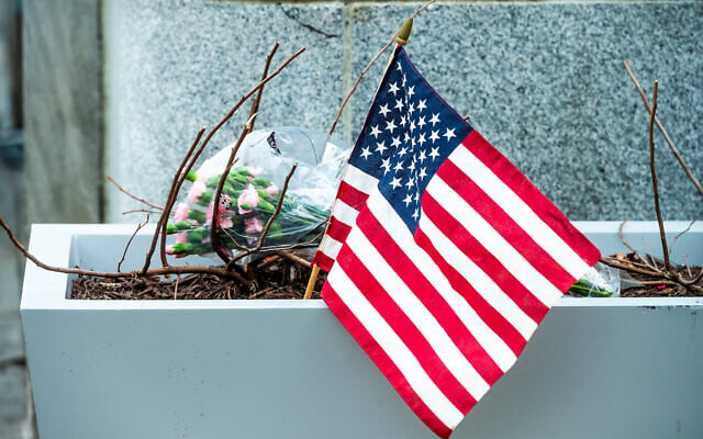 Flowers and an American flag, placed at the scene a day after two National Guard soldiers were shot near the White House in Washington, Nov. 27, 2025. (AP Photo/Cliff Owen) Flowers and an American flag, placed at the scene a day after two National Guard soldiers were shot near the White House in Washington, Nov. 27, 2025. (AP Photo/Cliff Owen)