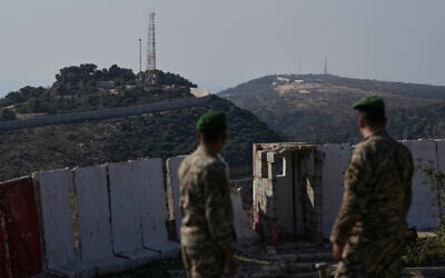 Lebanese army soldiers look at the Israeli military post of Hanita, left, and the Labbouneh post, one of five hills held by Israeli forces since last year, right, from a Lebanese military position in the village of Alma al-Shaab in south Lebanon, November 28, 2025. (AP/Bilal Hussein)