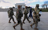 National Guard patrol the National Mall near the Lincoln Memorial, Nov. 28, 2025, in Washington. (AP Photo/Rahmat Gul)