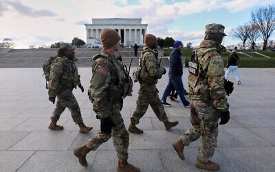 National Guard patrol the National Mall near the Lincoln Memorial, Nov. 28, 2025, in Washington. (AP Photo/Rahmat Gul)