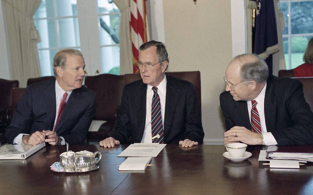 President George H.W. Bush, flanked by Secretary of State James A. Baker III, left, and Defense Secretary Dick Cheney talk in the Cabinet Room of the White House prior to a cabinet meeting, March 19, 1992. (AP Photo/J. Scott Applewhite)