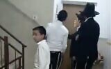 Haredi extremists chant "Traitor" and bang on the door of Shas MK Yinon Azoulay's apartment in Ashdod, November 19, 2025. (X screenshot)