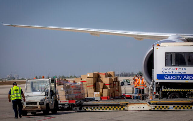 Airport workers unload packages from a freight plane at the Ben Gurion Airport on October 20, 2020. (Olivier Fitoussi/Flash90) Airport workers unload packages from a freight plane at the Ben Gurion Airport on October 20, 2020. (Olivier Fitoussi/Flash90)