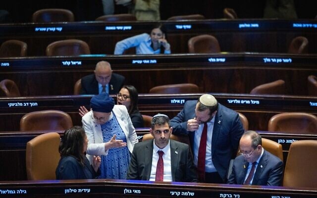 Communications Minister Shlomo Karhi, flanked by coalition ministers, attends a Knesset session in Jerusalem on October 22, 2025. (Chaim Goldberg/Flash90)