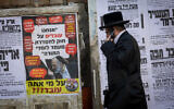 A poster showing Shas leader Aryeh Deri saying "We are working on a law to regulate the status of Torah students," with the text underneath reading, "Who are you fooling?" in an ultra-Orthodox neighborhood of Jerusalem on October 28, 2025. (Chaim Goldberg/FLASH90)