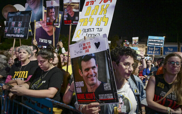 A woman holds a poster of slain captive Dror Or during a protest at Hostages Square in Tel Aviv calling for the release of the remaining hostages held by Hamas, November 8, 2025. (Avshalom Sassoni/Flash90)