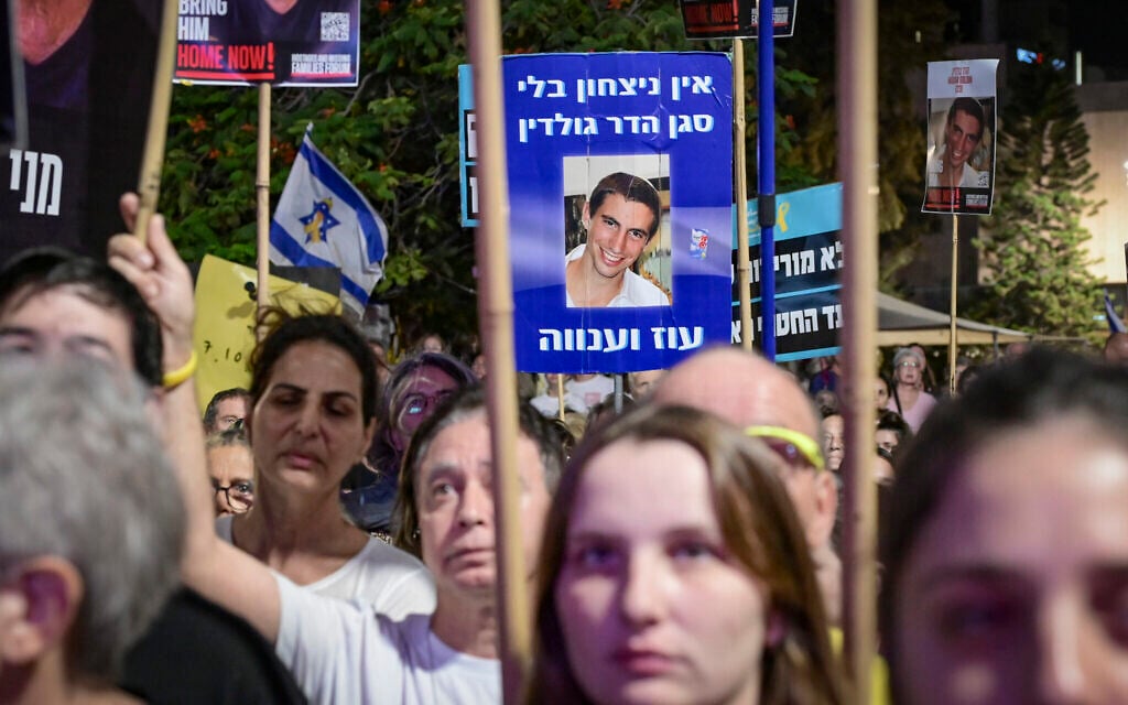 A poster of slain captive Lt. Hadar Goldin is held up by a demonstrator during a protest at Hostages Square in Tel Aviv calling for the release of the remaining hostages held by Hamas, November 8, 2025. (Avshalom Sassoni/Flash90)