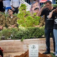 Ruby and Hagit, the parents of Staff Sgt. Itay Chen salute their son at his funeral at the military cemetery in Kiryat Shaul Cemetery in Tel Aviv on November 9, 2025 (Chaim Goldberg/Flash90)