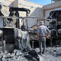 Man inspects burned trucks and cars following an attack by Israeli settlers in the village of Beit Lid, east of Tulkarm, in the West Bank, on November 12, 2025. (Nasser Ishtayeh/Flash90)