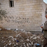 Palestinians inspect a mosque in Deir Istiya after it was set on fire by Israeli settlers, according to local residents. Graffiti left by settlers reads "We will take revenge again" and "We are not afraid of Avi Bluth," a reference to the IDF Central Command chief, November 13, 2025. (Nasser Ishtayeh/Flash90)