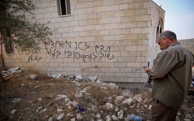 Palestinians inspect a mosque in Deir Istiya after it was set on fire by Israeli settlers, according to local residents. Graffiti left by settlers reads "We will take revenge again" and "We are not afraid of Avi Bluth," a reference to the IDF Central Command chief, November 13, 2025. (Nasser Ishtayeh/Flash90)