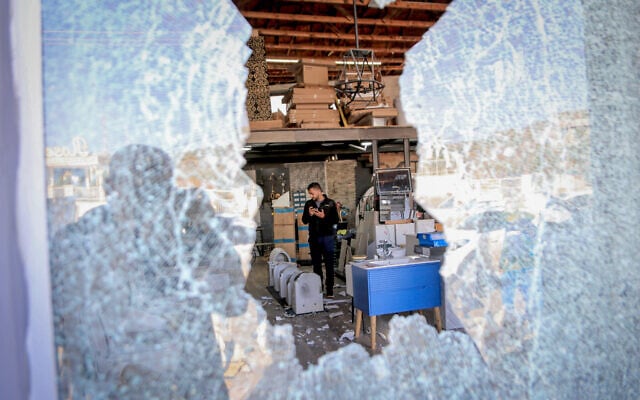 A Palestinian inspects the damage to a warehouse following an attack by Israeli settlers in the town of Deir Sharaf, west of Nablus, in the West Bank, November
19, 2025. (Nasser Ishtayeh/Flash90) A Palestinian inspects the damage to a warehouse following an attack by Israeli settlers in the town of Deir Sharaf, west of Nablus, in the West Bank, November
19, 2025. (Nasser Ishtayeh/Flash90)