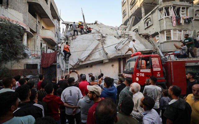 Palestinians at the site of an Israeli airstrike in Nuseirat, central Gaza, on November 22, 2025. (Ali Hassan/Flash90)