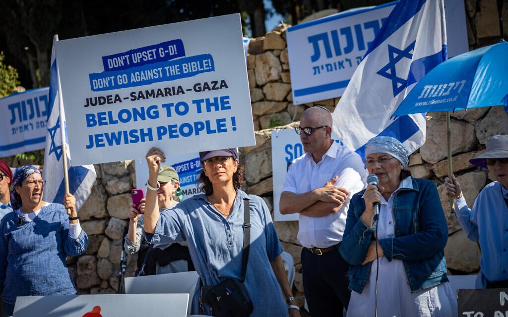 People take part in a demonstration calling for Israeli sovereignty over the West Bank and opposing a Palestinian state, outside the weekly cabinet meeting at the Prime Minister’s Office in Jerusalem, November 23, 2025. (Yonatan Sindel/Flash90) People take part in a demonstration calling for Israeli sovereignty over the West Bank and opposing a Palestinian state, outside the weekly cabinet meeting at the Prime Minister’s Office in Jerusalem, November 23, 2025. (Yonatan Sindel/Flash90)