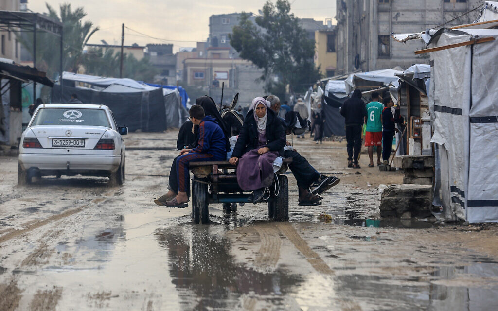 Palestinians seen in a flooded street after a rainstorm in Khan Younis, in the southern Gaza Strip, November 25, 2025. (Abed Rahim Khatib/Flash90) Palestinians seen in a flooded street after a rainstorm in Khan Younis, in the southern Gaza Strip, November 25, 2025. (Abed Rahim Khatib/Flash90)