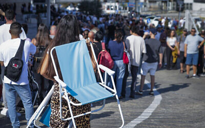 Thousands of people wait in line to schedule an appointment at the Portuguese Embassy in Israel, in central Israel, November 28, 2025. (Tal Gal/Flash90)