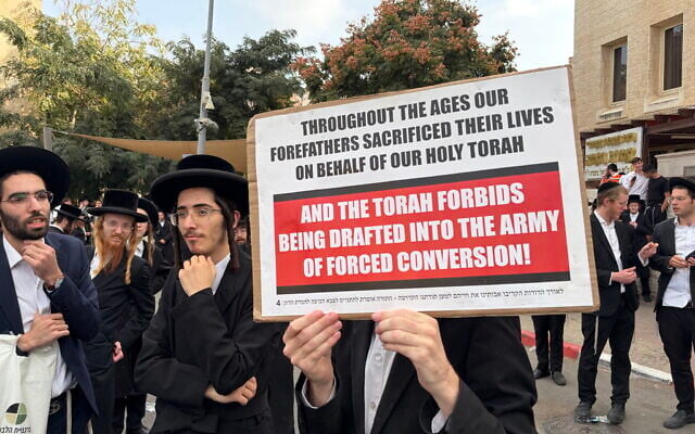 Ultra-Orthodox Jews protest outside the IDF recruitment center in Jerusalem on November 12, 2025 (Sam Sokol/Times of Israel)