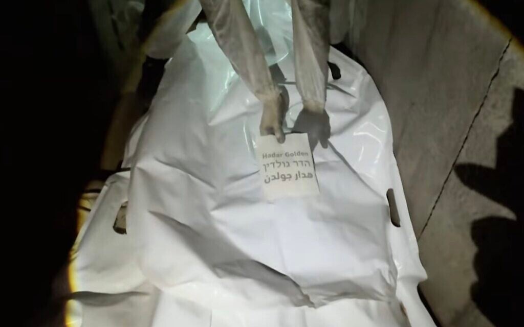 Al Jazeera footage broadcast on November 8, 2025, shows what it says is a Hamas operative placing a nametag on a body bag, allegedly that of IDF soldier Hadar Goldin, killed in the 2014 Israel-Hamas war, inside a tunnel in Gaza's Rafah. (Al Jazeera Screenshot)