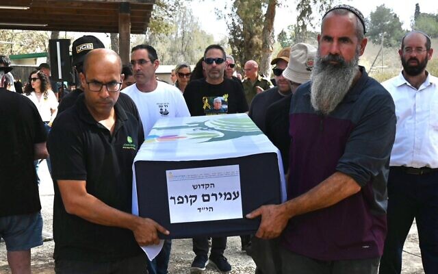 Rotem Cooper, center, at the funeral of his father, hostage Amiram Cooper, whose body was buried on November 2, 2025, at Kibbutz Nir Oz. (Uriel Even Sapir/Hostages Forum) Rotem Cooper, center, at the funeral of his father, hostage Amiram Cooper, whose body was buried on November 2, 2025, at Kibbutz Nir Oz. (Uriel Even Sapir/Hostages Forum)