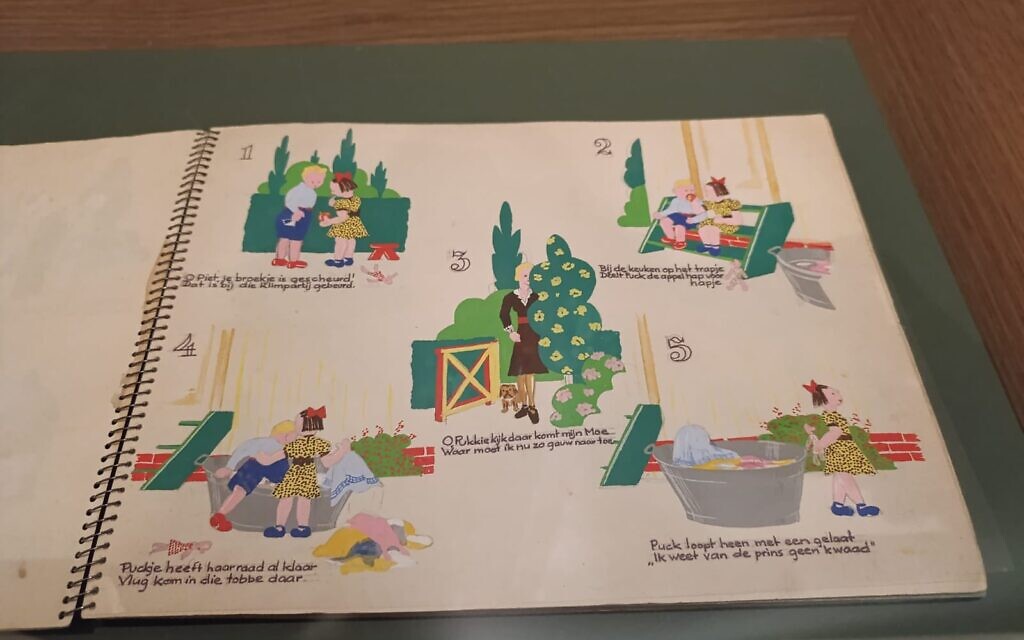 A picture book illustrating how a family hid from the Nazis during the Holocaust, displayed in Yad Vashem's Living Memory exhibition (Zev Stub/Times of Israel)